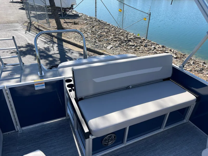 Slide: The Image of 2025 Godfrey Xperience 2286 SFL pontoon boat with comfortable seating by the water. - 15