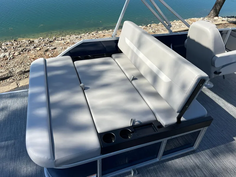 Slide: The Image of 2025 Godfrey Xperience 2286 SFL boat with spacious seating by the water. - 17