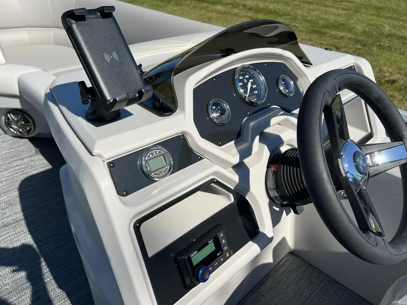 Slide: The Image of 2025 Godfrey Xperience 2286 SFL boat dashboard with steering wheel and gauges. - 23