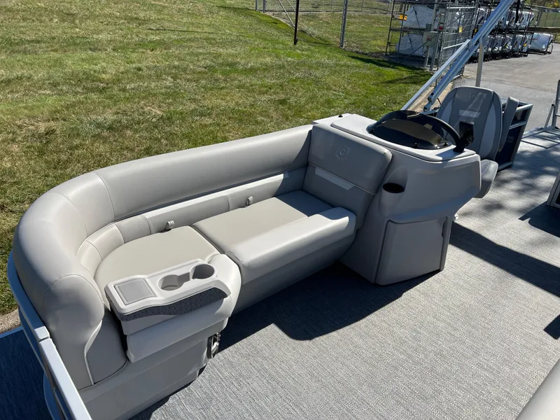 Slide: The Image of 2025 Godfrey Xperience 2286 SFL pontoon boat interior with gray seating and steering console. - 9