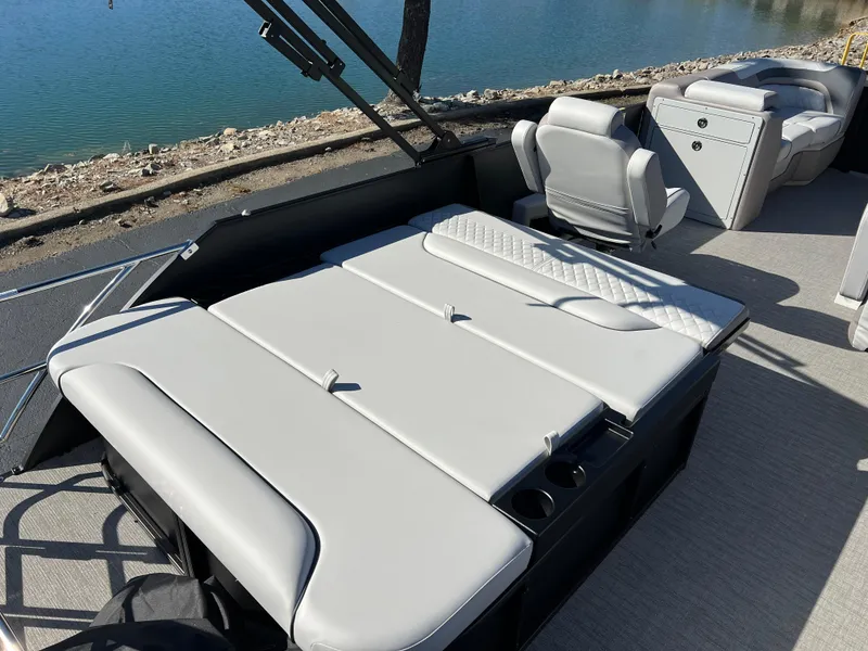 Slide: The Image of 2025 Godfrey SWEETWATER 2286 SFL pontoon boat interior with seating and water view. - 19
