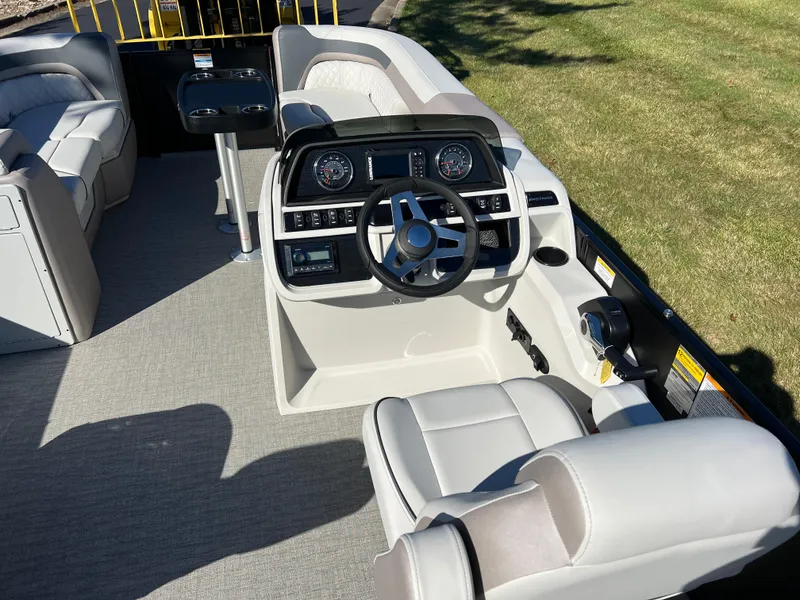 Slide: The Image of 2025 Godfrey SWEETWATER 2286 SFL boat interior with modern steering console and seating. - 21