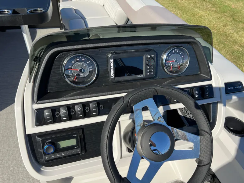 Slide: The Image of 2025 Godfrey SWEETWATER 2286 SFL dashboard with steering wheel and control panel. - 22