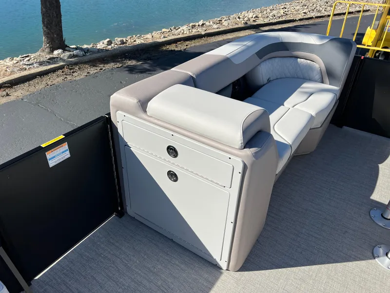 Slide: The Image of 2025 Godfrey SWEETWATER 2286 SFL boat interior with plush seating by the water. - 24