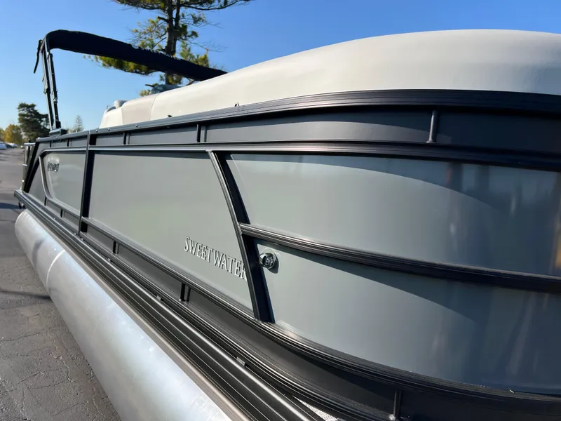 Slide: The Image of 2025 Godfrey SWEETWATER 2286 SFL pontoon boat, sleek design, side view. - 4