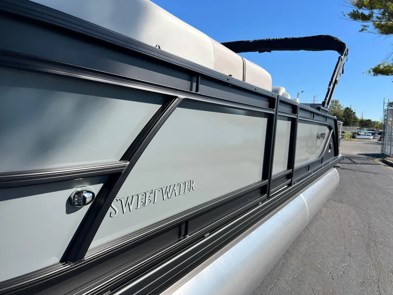 Slide: The Image of 2025 Godfrey SWEETWATER 2286 SFL pontoon boat, sleek design, side view, sunny day. - 7