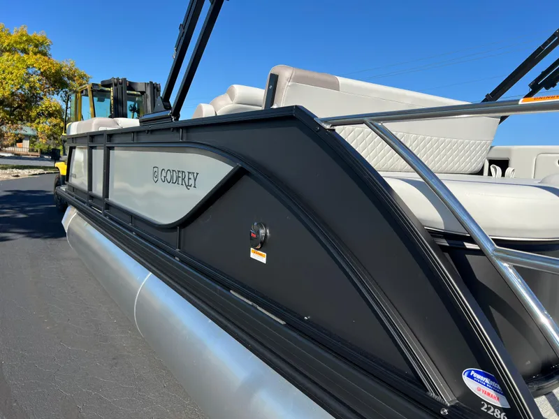 Slide: The Image of 2025 Godfrey SWEETWATER 2286 SFL pontoon boat, sleek design, black exterior, comfortable seating. - 8