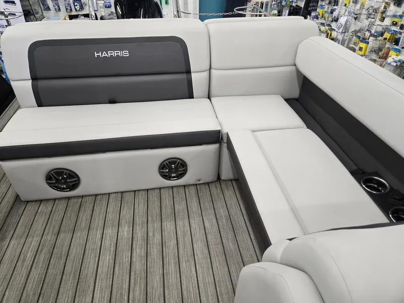 Slide: The Image of 2024 Harris Cruiser 230 boat interior with gray seating and integrated speakers. - 10
