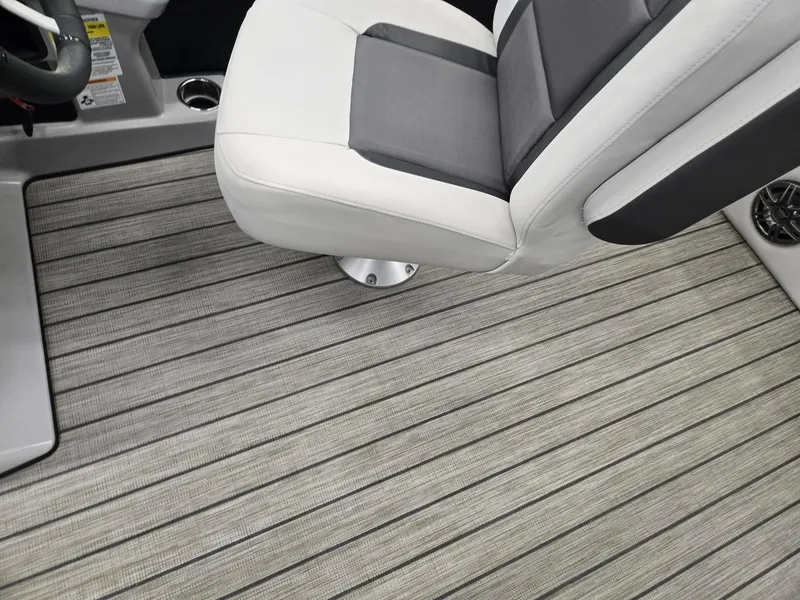 Slide: The Image of 2024 Harris Cruiser 230 interior with striped flooring and a sleek, modern seat design. - 11
