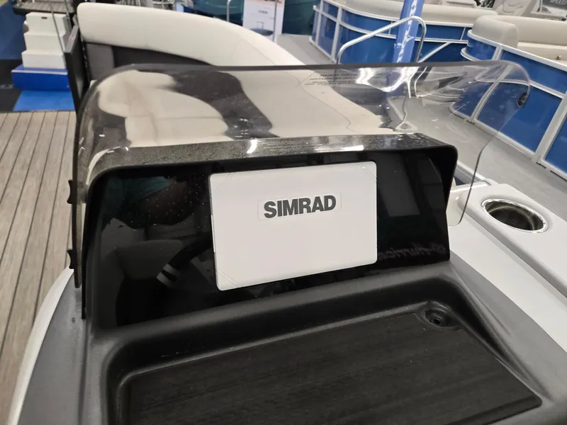 Slide: The Image of 2024 Harris Cruiser 230 boat dashboard with Simrad navigation system. - 14