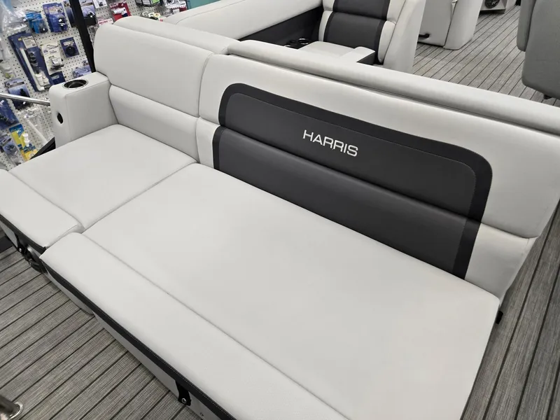Slide: The Image of 2024 Harris Cruiser 230 boat interior with gray seating and logo. - 20