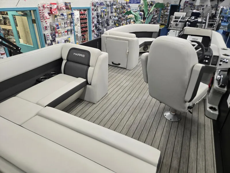 Slide: The Image of 2024 Harris Cruiser 230 interior with plush seating and modern design in a showroom. - 22