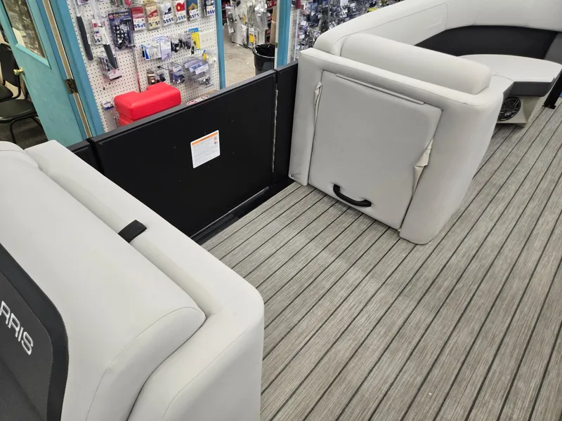 Slide: The Image of 2024 Harris Cruiser 230 boat interior with gray seating and wood-style flooring. - 23