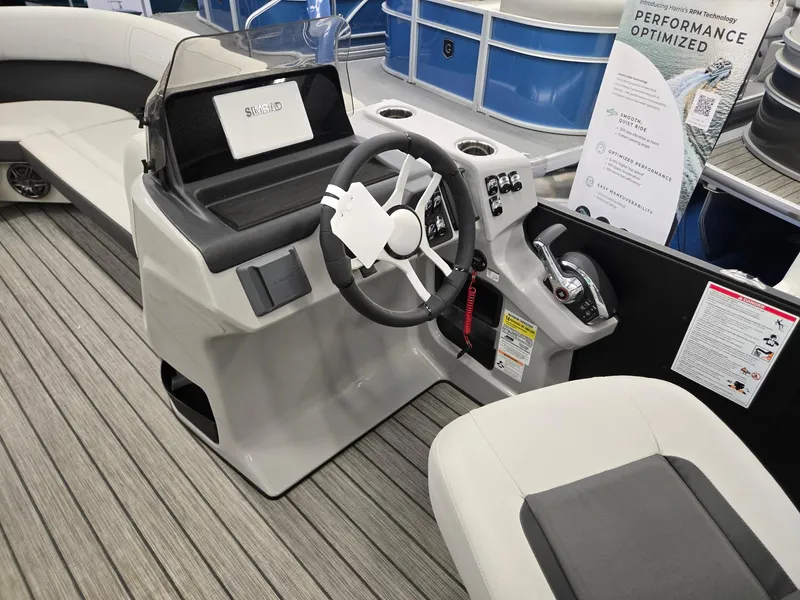 Slide: The Image of 2024 Harris Cruiser 230 boat interior with steering wheel and seating, showcasing modern design. - 25