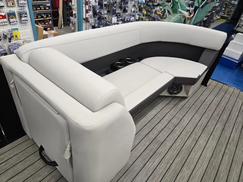 Slide: The Image of 2024 Harris Cruiser 230 boat seating, featuring plush white upholstery and integrated cup holders. - 27