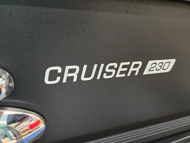 Slide: The Image of 2024 Harris Cruiser 230 logo on a sleek black surface. - 28