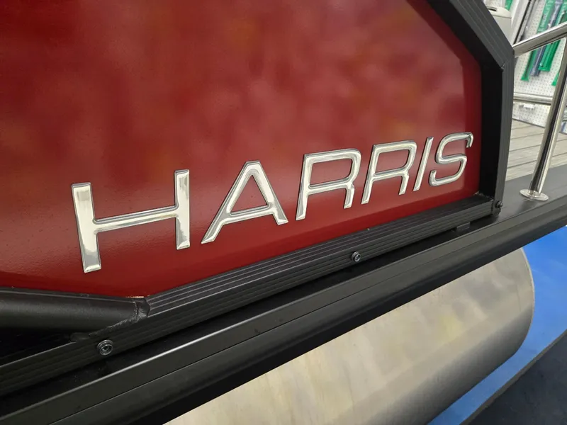 Slide: The Image of 2024 Harris Cruiser 230 boat with red panel and silver logo. - 30