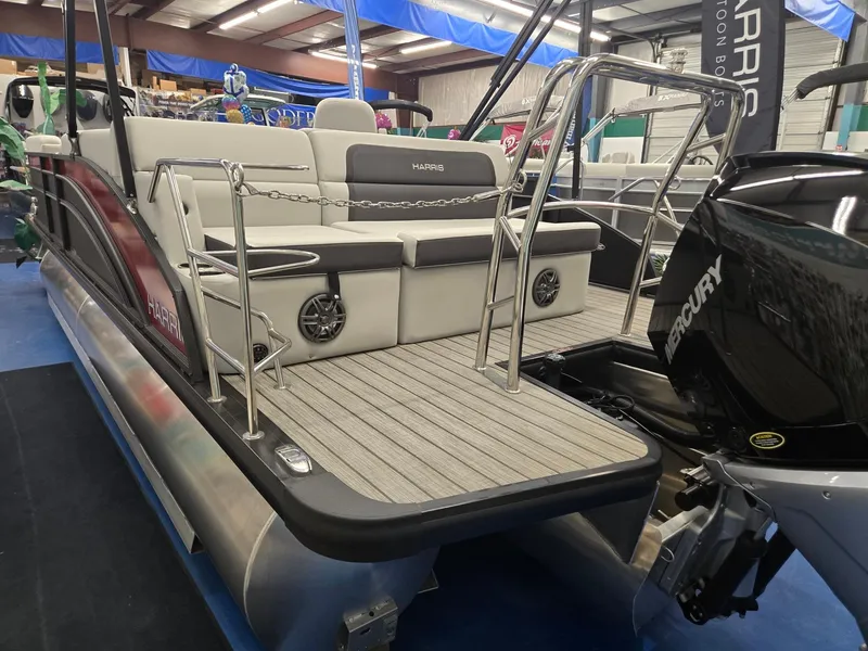 Slide: The Image of 2024 Harris Cruiser 230 pontoon boat with Mercury engine, featuring spacious seating and modern design. - 4