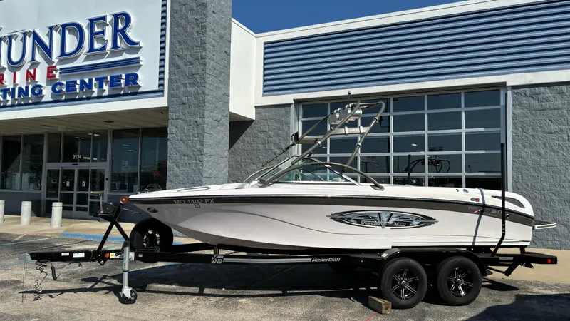 The Image of 2005 Correct Craft SV211 Nautique Air boat on trailer outside dealership. - 0