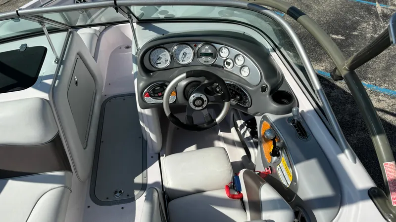 Slide: The Image of 2005 Correct Craft SV211 Nautique Air boat interior with dashboard and steering wheel. - 11