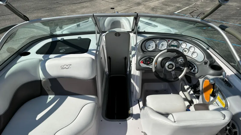 Slide: The Image of 2005 Correct Craft SV211 Nautique Air boat interior with steering wheel and seating. - 14