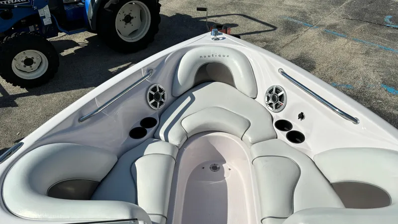 Slide: The Image of 2005 Correct Craft SV211 Nautique Air boat interior with cushioned seating and speakers. - 19