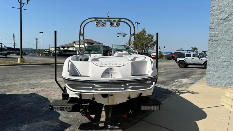 Slide: The Image of 2005 Correct Craft SV211 Nautique Air boat on trailer in parking lot. - 2