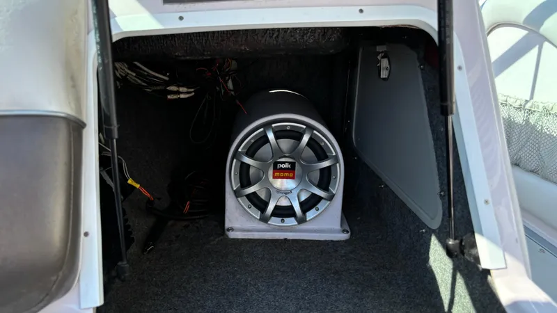 Slide: The Image of 2005 Correct Craft SV211 Nautique Air with Polk audio subwoofer in storage compartment. - 23
