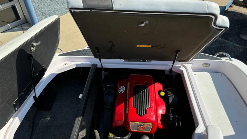 Slide: The Image of 2005 Correct Craft SV211 Nautique Air engine compartment with red engine cover. - 25