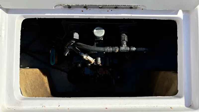 Slide: The Image of 2005 Correct Craft SV211 Nautique Air engine compartment with visible hoses and components. - 30