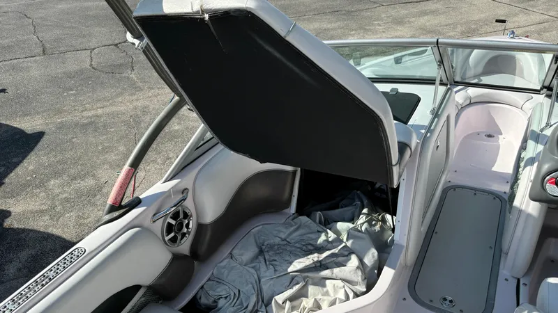 Slide: The Image of 2005 Correct Craft SV211 Nautique Air interior with open storage compartment. - 32