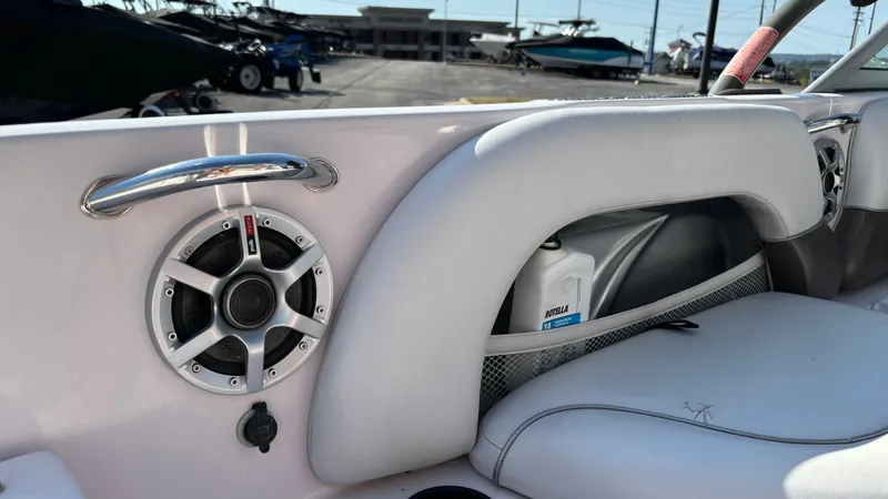Slide: The Image of 2005 Correct Craft SV211 Nautique Air interior with speaker and storage compartment. - 33
