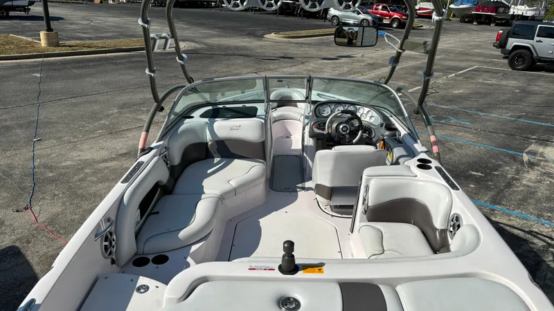Slide: The Image of 2005 Correct Craft SV211 Nautique Air boat interior with seating and steering wheel. - 4