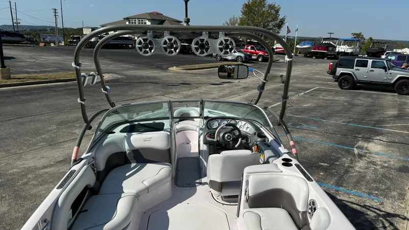 Slide: The Image of 2005 Correct Craft SV211 Nautique Air boat interior with tower speakers in parking lot. - 5