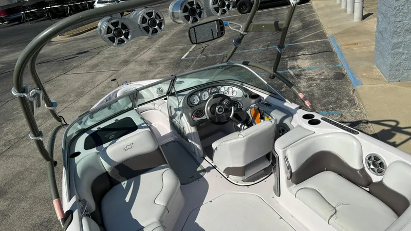 Slide: The Image of 2005 Correct Craft SV211 Nautique Air boat interior with seating and dashboard. - 6