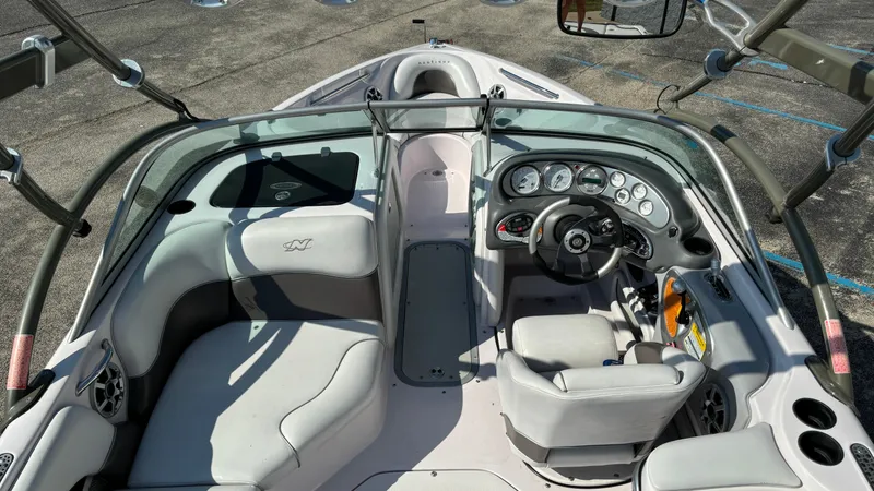 Slide: The Image of 2005 Correct Craft SV211 Nautique Air boat interior with steering wheel and seating. - 7