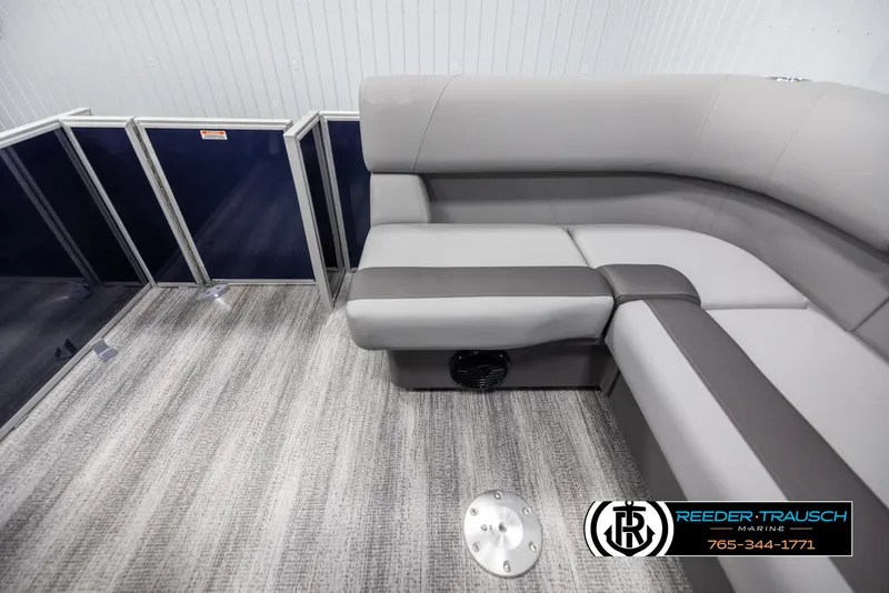 Slide: The Image of 2025 Bennington 188 SSSE boat interior with gray seating and carpeted flooring. - 15
