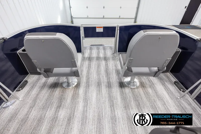 Slide: The Image of 2025 Bennington 188 SSSE boat interior with two gray seats and carpeted flooring. - 18