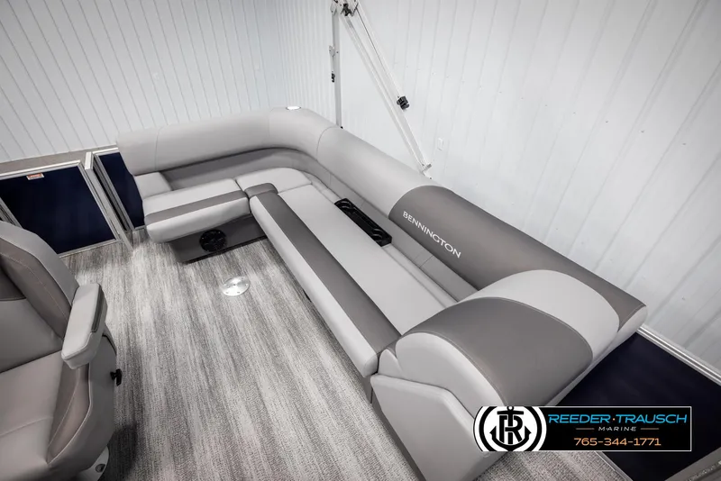 Slide: The Image of 2025 Bennington 188 SSSE boat interior with gray seating and carpeted flooring. - 20