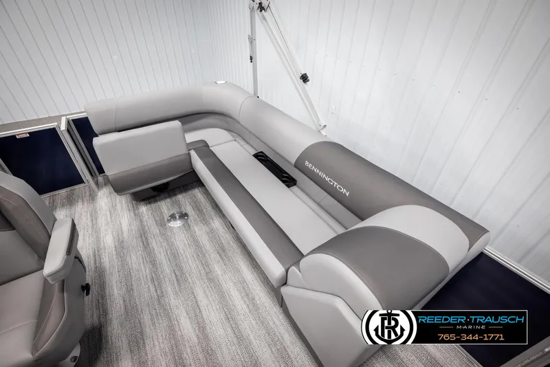 Slide: The Image of 2025 Bennington 188 SSSE boat interior with gray seating and logo, Reeder-Trausch Marine branding. - 21