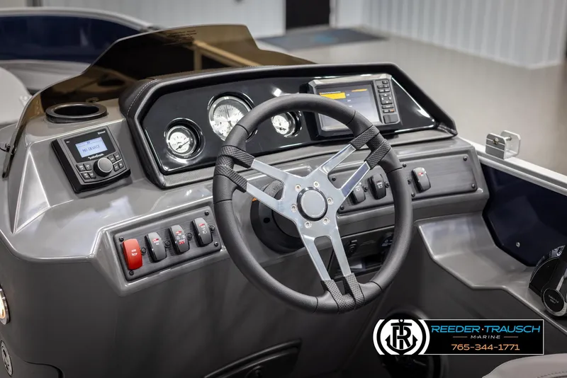 Slide: The Image of 2025 Bennington 188 SSSE boat dashboard with steering wheel and control panel. - 25