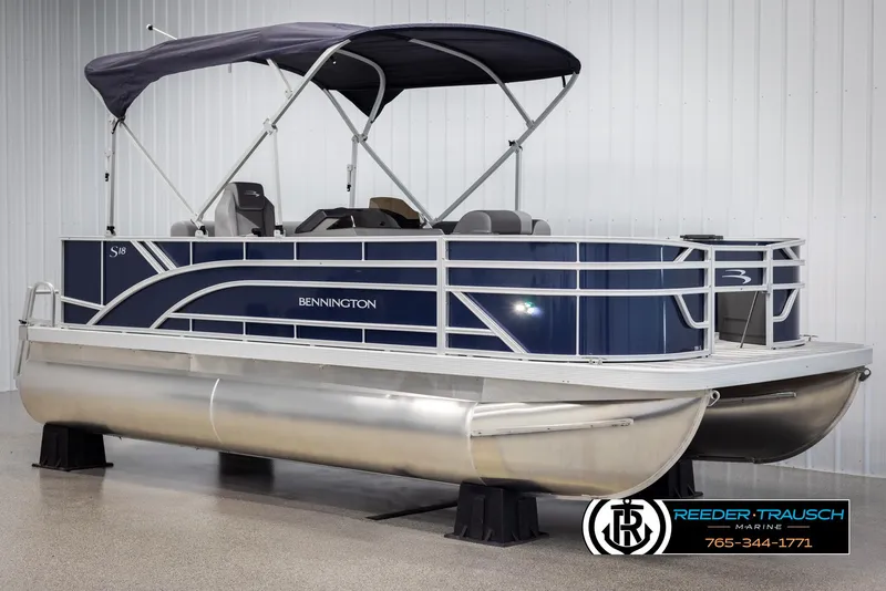 Slide: The Image of 2025 Bennington 188 SSSE pontoon boat with canopy, displayed indoors at Reeder-Trausch Marine. - 3