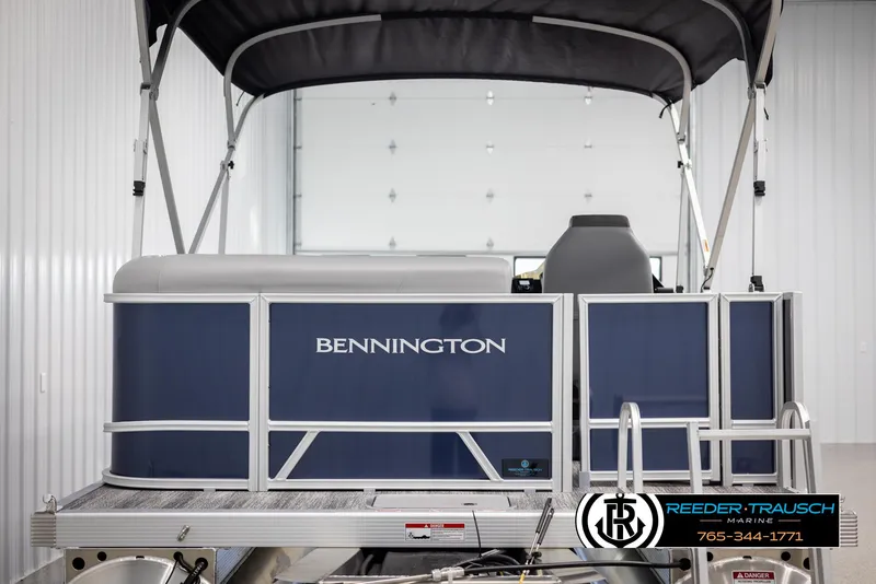 Slide: The Image of 2025 Bennington 188 SSSE pontoon boat in a showroom with canopy. - 7