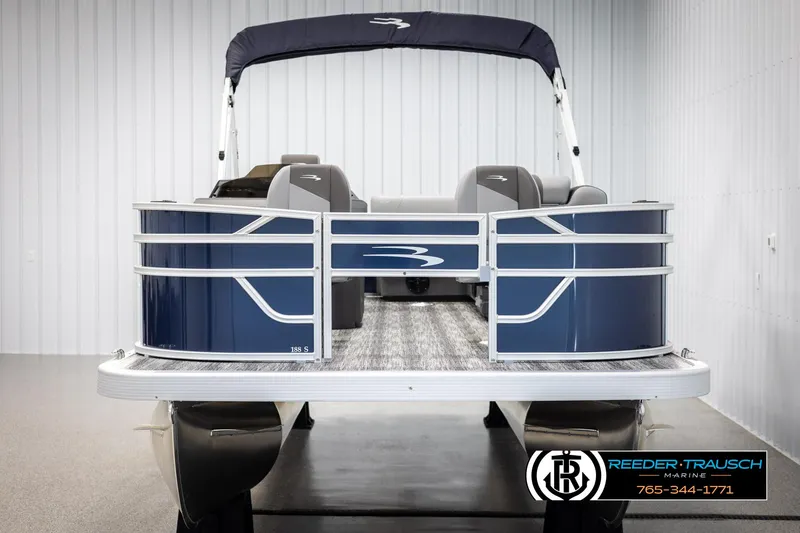 Slide: The Image of 2025 Bennington 188 SSSE pontoon boat in showroom, featuring sleek blue design and canopy. - 8
