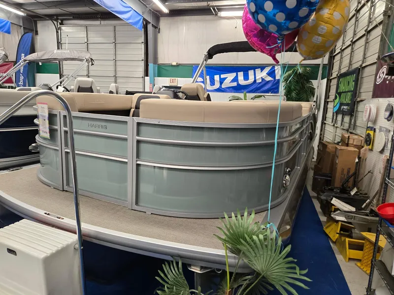 The Image of 2025 Harris Cruiser 210 pontoon boat displayed indoors with colorful balloons. - 0
