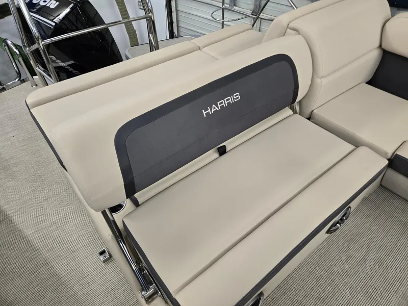Slide: The Image of 2025 Harris Cruiser 210 boat interior with beige seating and Harris branding. - 13