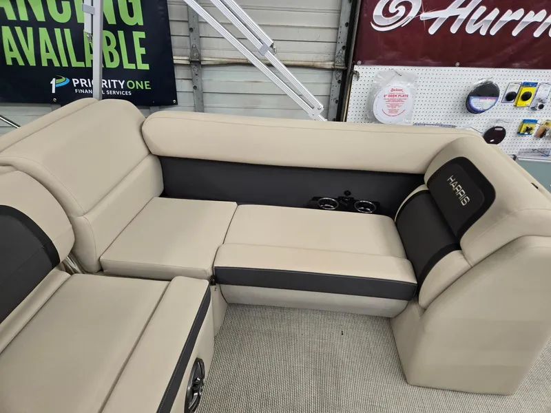 Slide: The Image of 2025 Harris Cruiser 210 boat interior with beige seating and cup holders. - 14