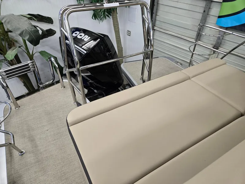 Slide: The Image of 2025 Harris Cruiser 210 boat interior with seating and motor, showcasing modern design. - 15