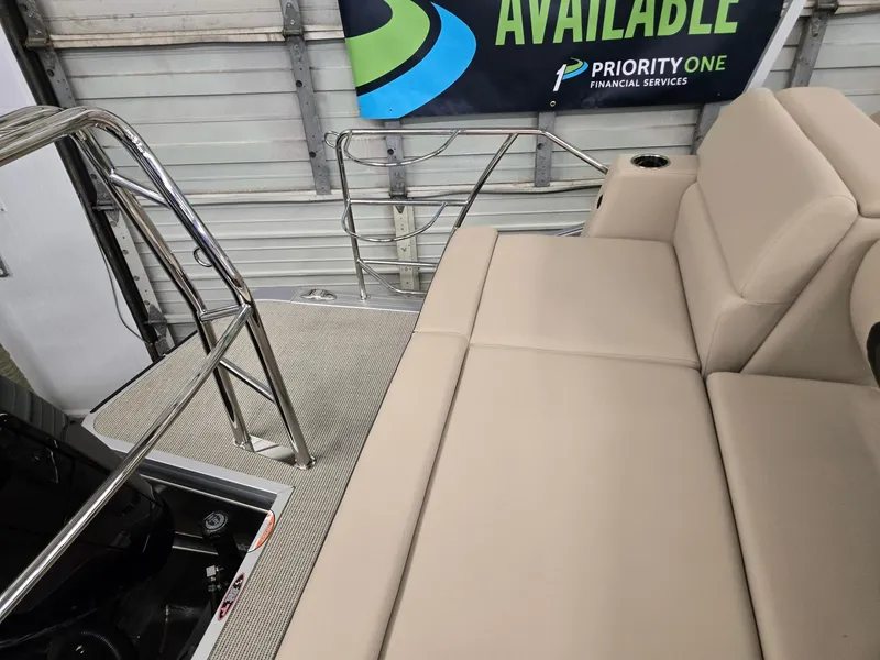 Slide: The Image of 2025 Harris Cruiser 210 interior with beige seating and stainless steel railings. - 17