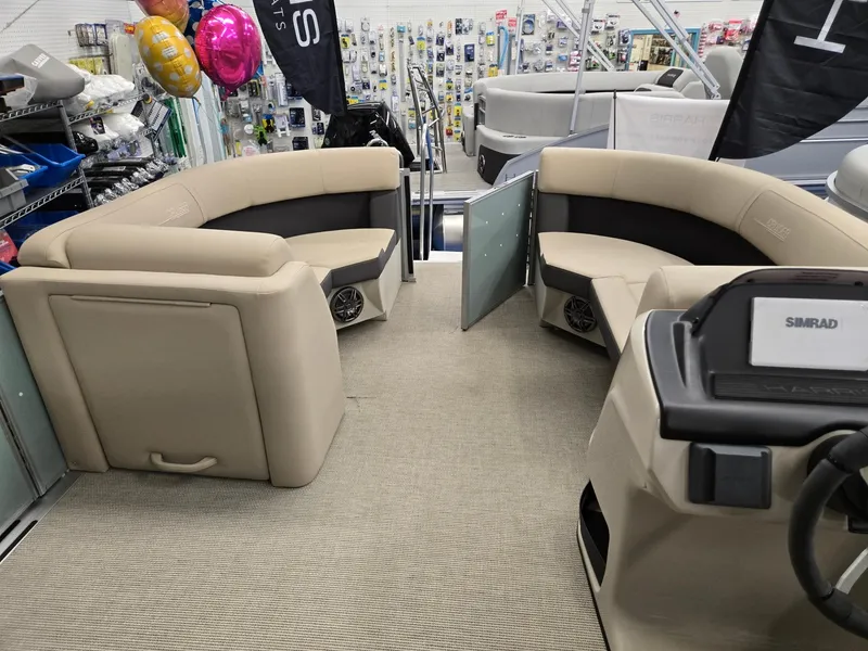 Slide: The Image of 2025 Harris Cruiser 210 interior with beige seating and modern dashboard. - 20